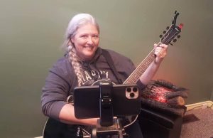 Leah playing guitar for Folk Music Ontario Campfire Song Swap